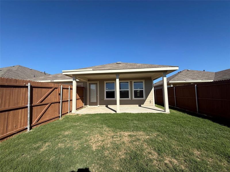 Back of house featuring a patio area and a yard