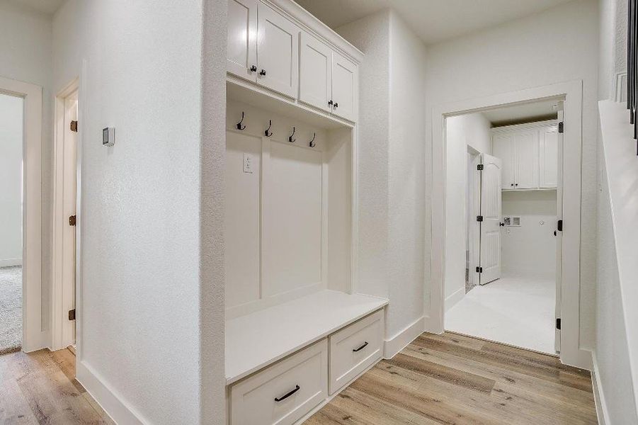 Mudroom with light hardwood / wood-style floors