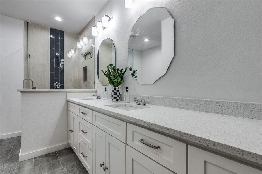 Bathroom featuring tile patterned floors and dual vanity