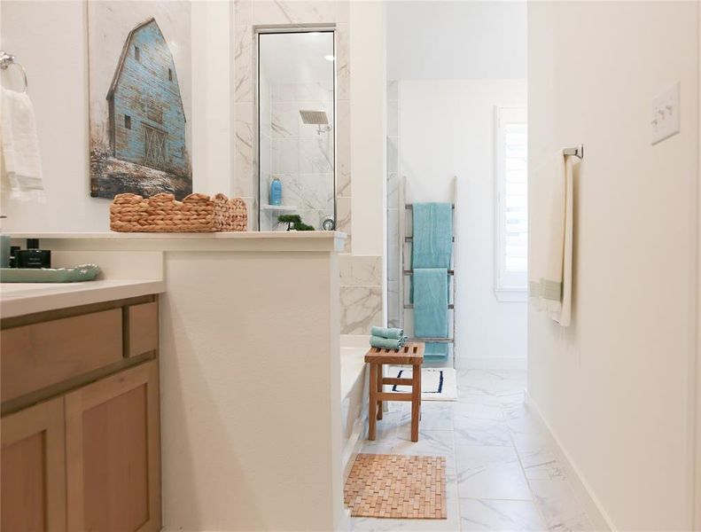 Bathroom with vanity, an enclosed shower, and tile patterned flooring