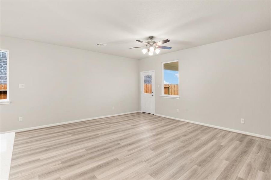 Your family room has ample space to entertain family and friends. This space features beautiful floors, fresh paint, ceiling fan with lighting, and high ceilings.