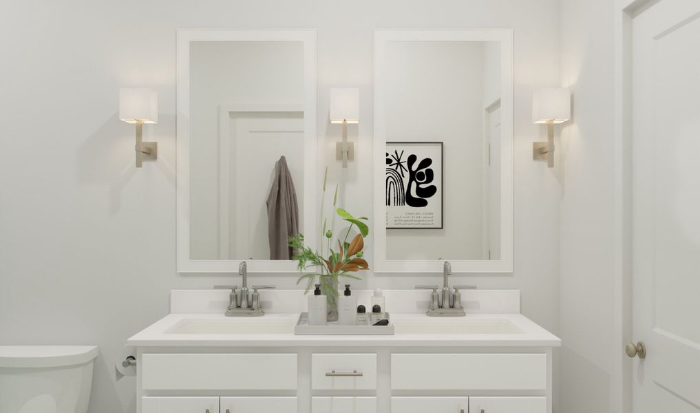 Primary bath with dual sinks and white-framed mirrors