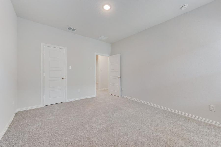 Unfurnished bedroom with light carpet