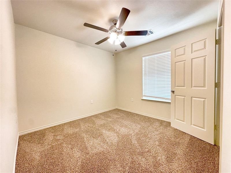 Empty room with ceiling fan and carpet