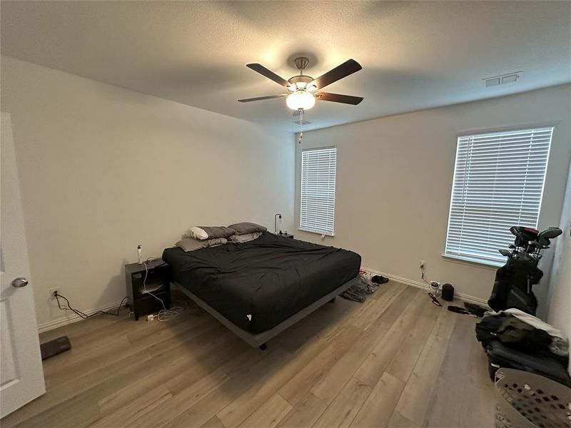 Bedroom featuring light hardwood / wood-style flooring and ceiling fan