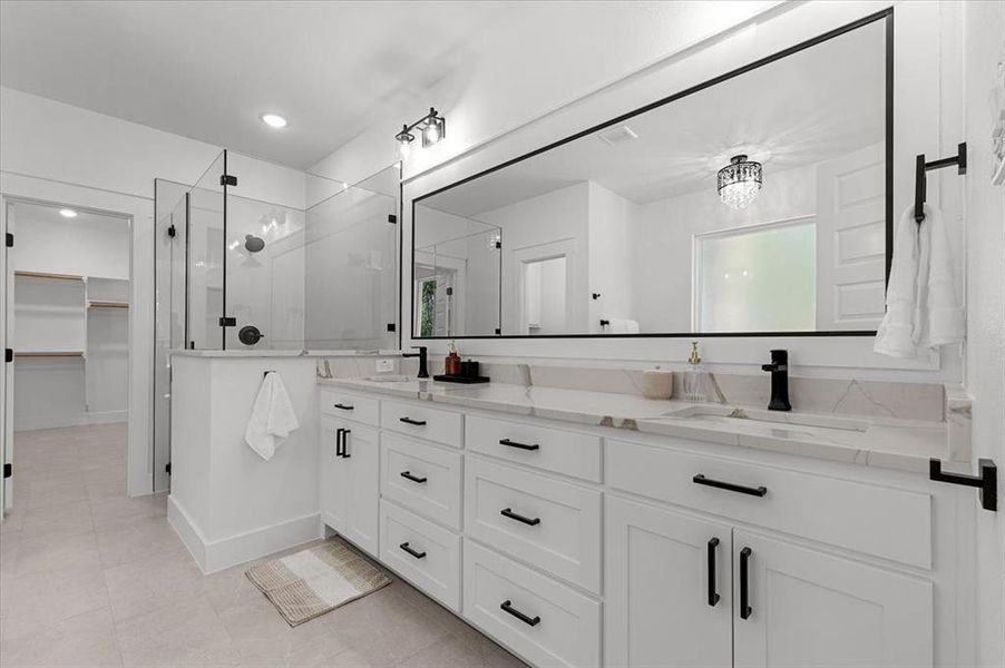 Bathroom featuring vanity, tile patterned floors, and an enclosed shower