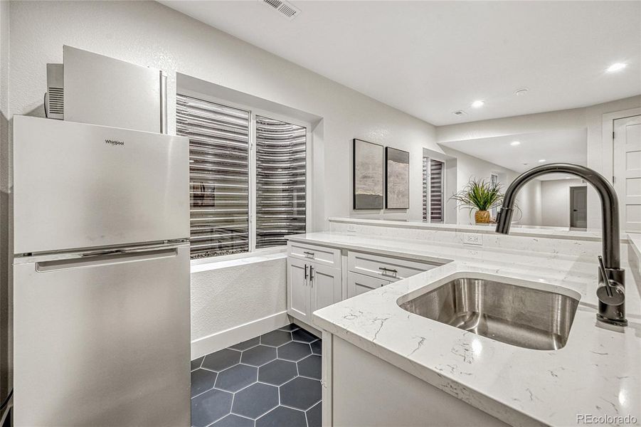 This space offers tile flooring, spacious countertops and plenty of cabinetry.