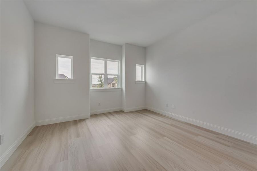 Unfurnished room with light hardwood / wood-style flooring