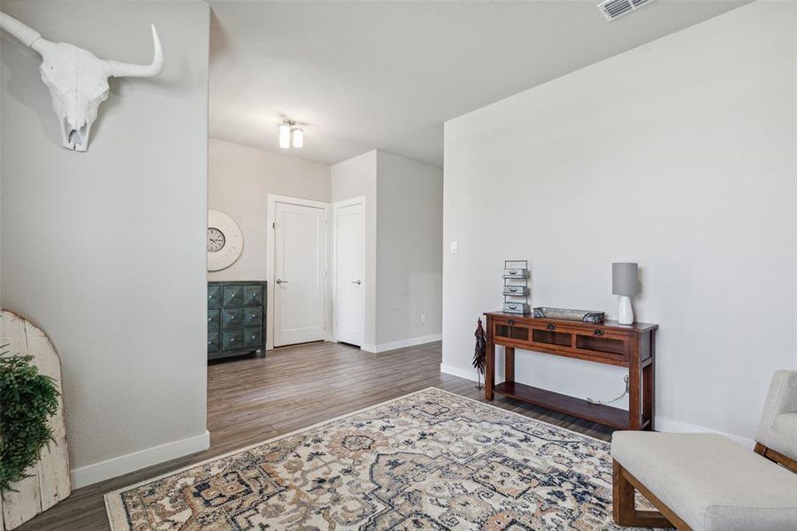 Flex room with view of the coat closet and door going to attached garage