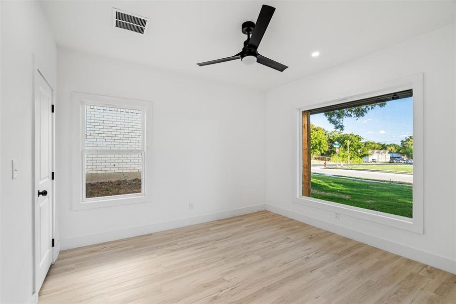 Unfurnished room with light hardwood / wood-style flooring and ceiling fan