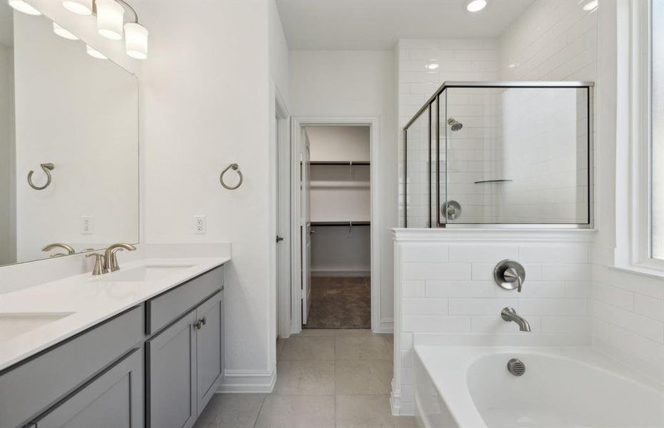 Elegant owner's bathroom with dual vanity *real home pictured