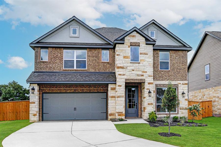 Gorgeous blend of brick, stone, and stucco exterior with wood siding.