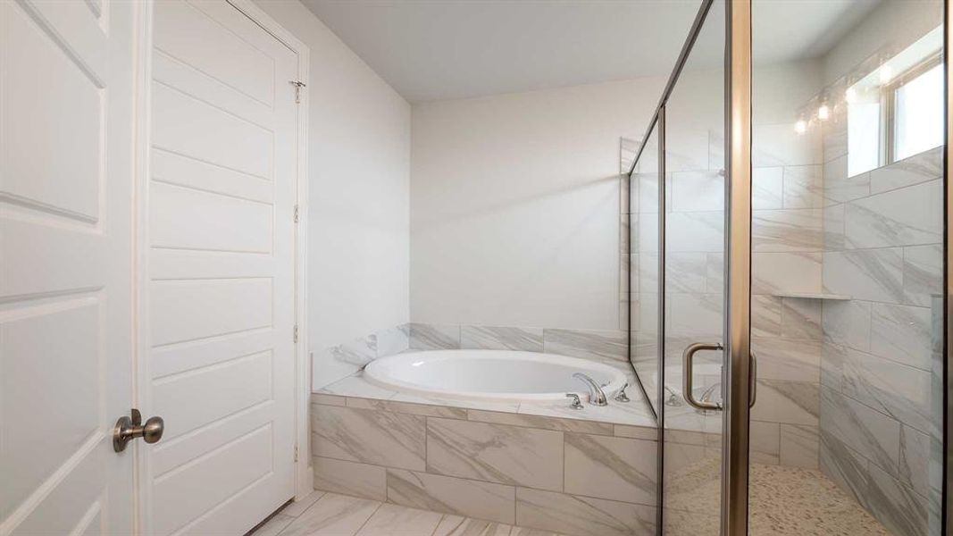 Bathroom with tile patterned floors and separate shower and tub