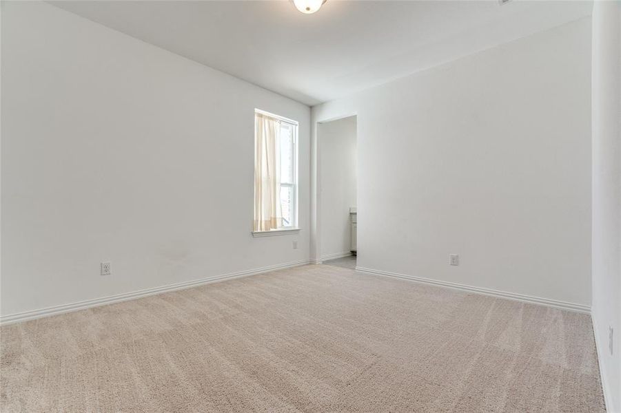 Unfurnished room featuring light colored carpet