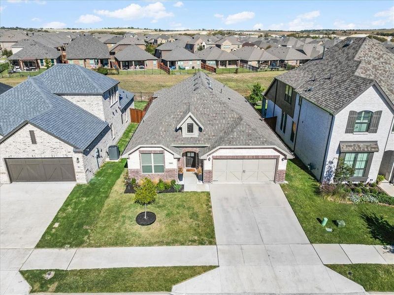 View of front of home featuring a front yard and a garage