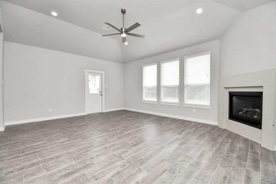 Take another glimpse into the heart of the home with this additional view of the family room—a sprawling space ready to accommodate all your gatherings. Sample photo of completed home with similar floor plan. As-built interior colors and selections may vary.