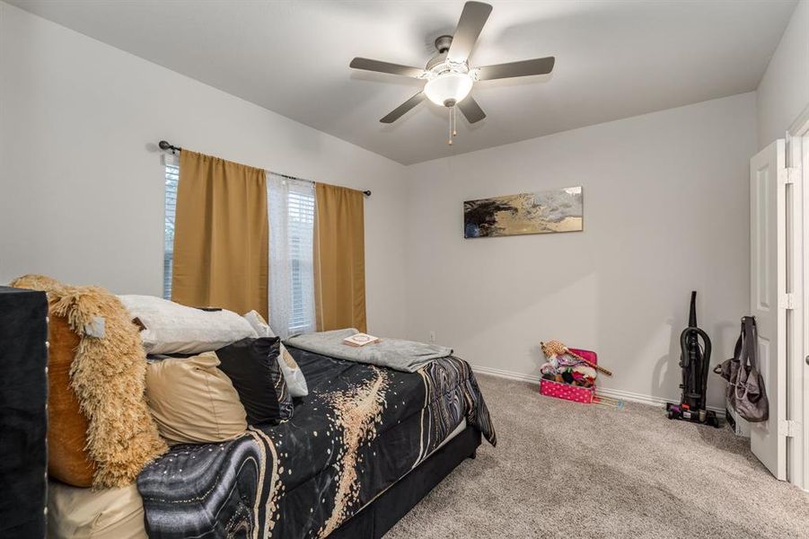 Bedroom featuring carpet and ceiling fan