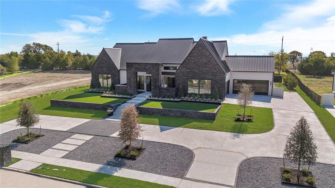 View of front of home with a front lawn and a garage