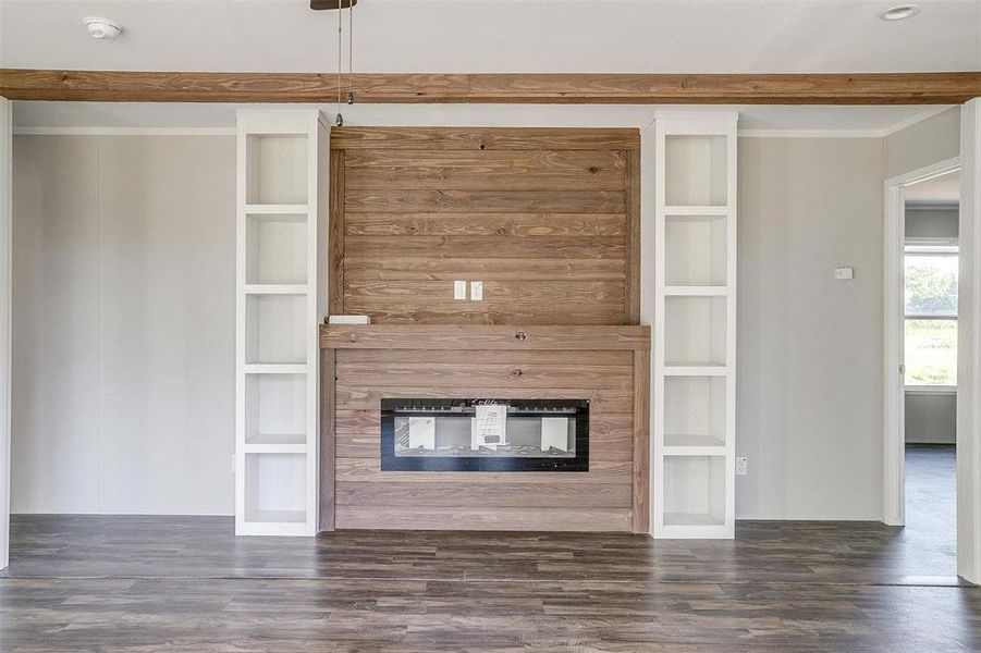 Unfurnished living room featuring built in features and dark hardwood / wood-style floors