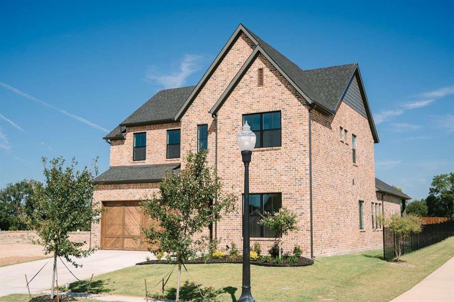 View of front facade with a front lawn and a garage