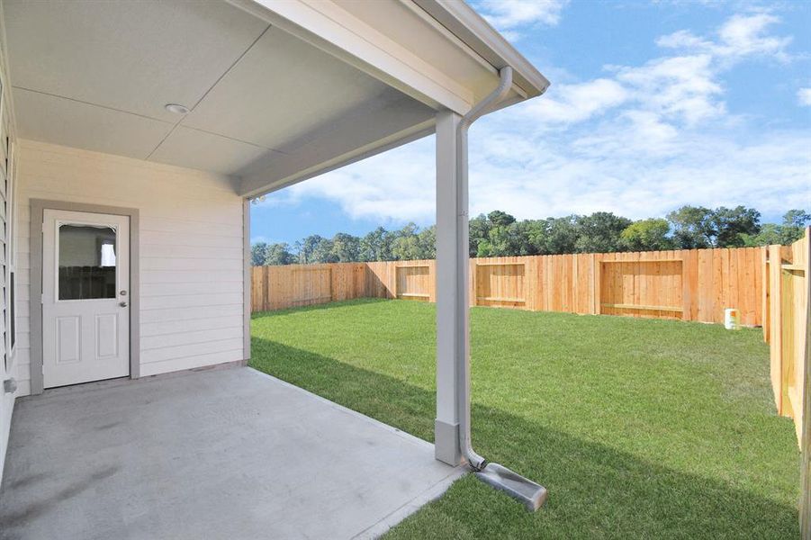 Experience outdoor living at its finest on this expansive covered patio, thoughtfully designed for BBQs and delightful outdoor dining.