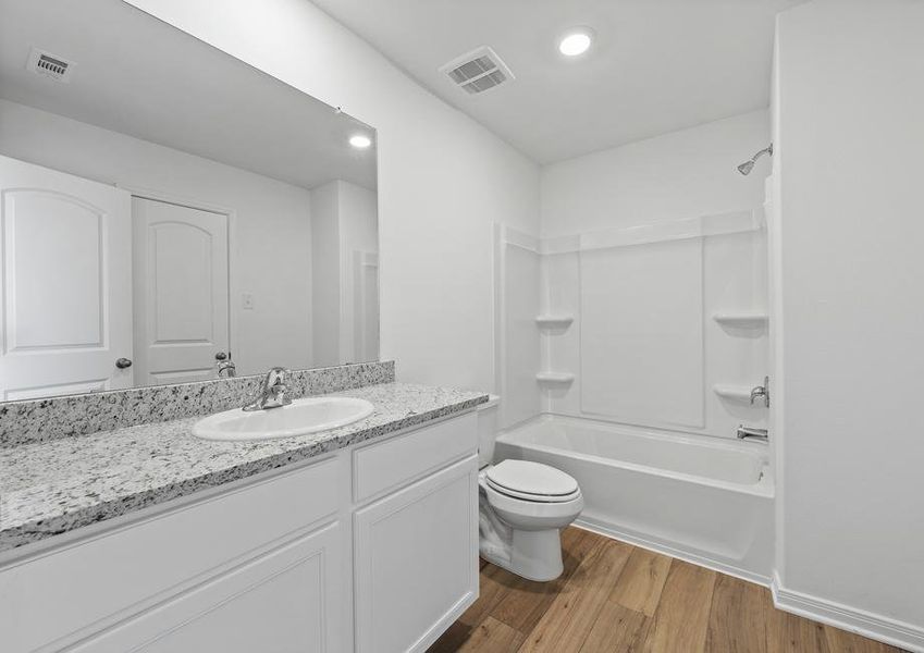 A spacious secondary bathroom.