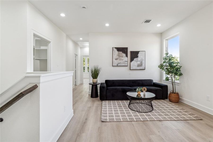 A generously sized powder room retreat features a clean, contemporary aesthetic. With sleek design and thoughtful details, it offers a luxurious experience for guests, blending style and comfort.