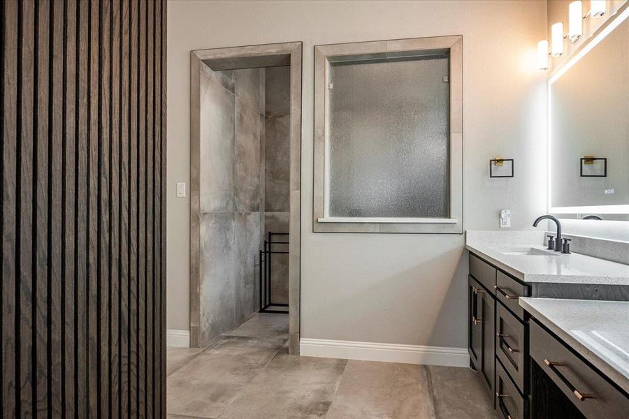 Bathroom featuring tile patterned flooring and vanity