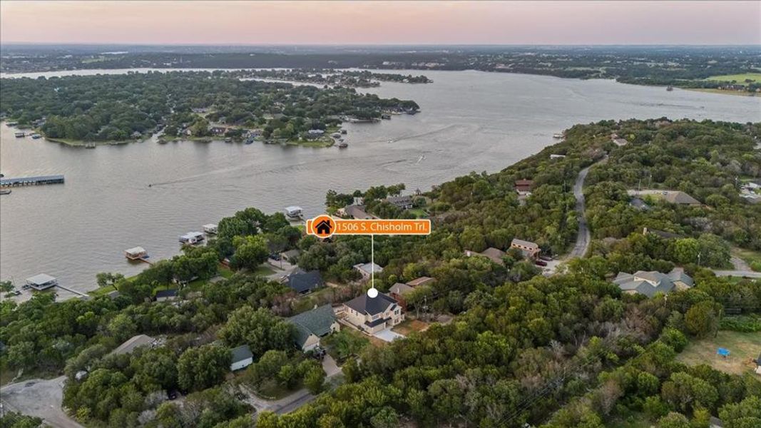 Aerial view at dusk featuring a water view