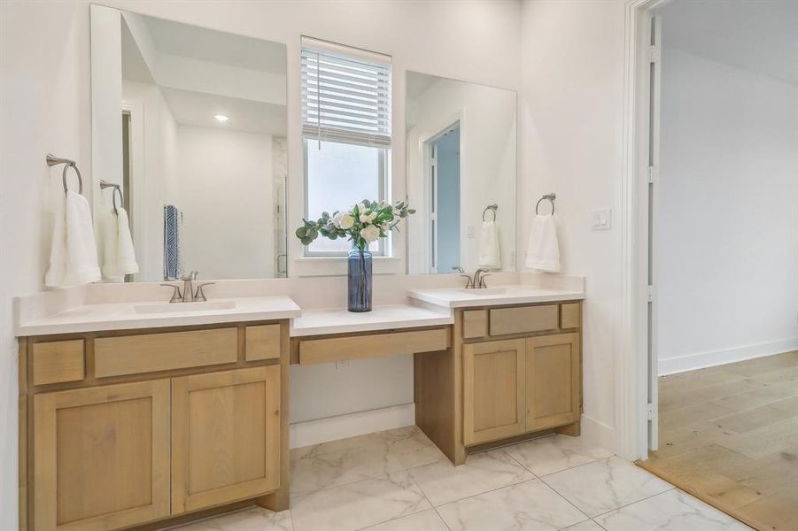 Bathroom featuring double vanity and wood-type flooring