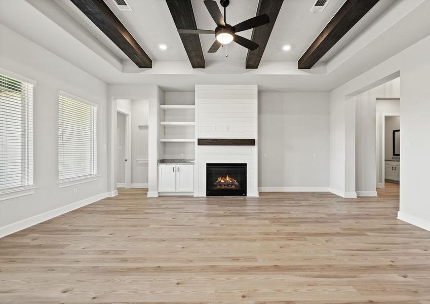 A stately fireplace includes shiplap detailing.