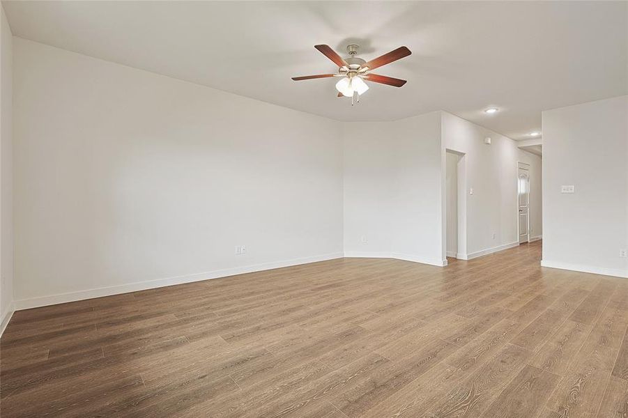 Unfurnished room featuring wood-type flooring and ceiling fan