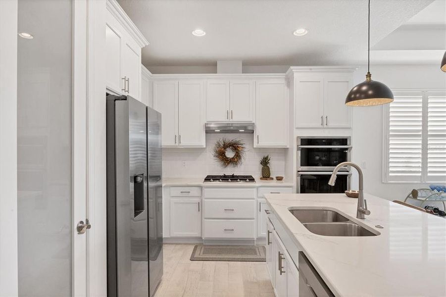 Kitchen has quartz countertops.