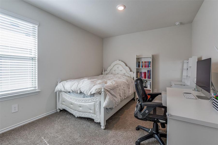 Bedroom featuring carpet and multiple windows