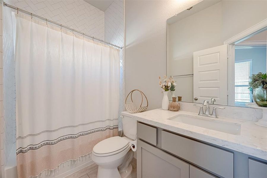 Third bathroom features atub/shower combo and plenty of counter space.