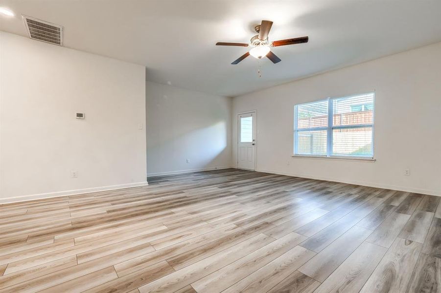 Empty room featuring light wood-type flooring and ceiling fan