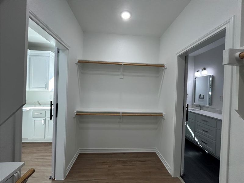 Master closet separating laundry room and master bathroom