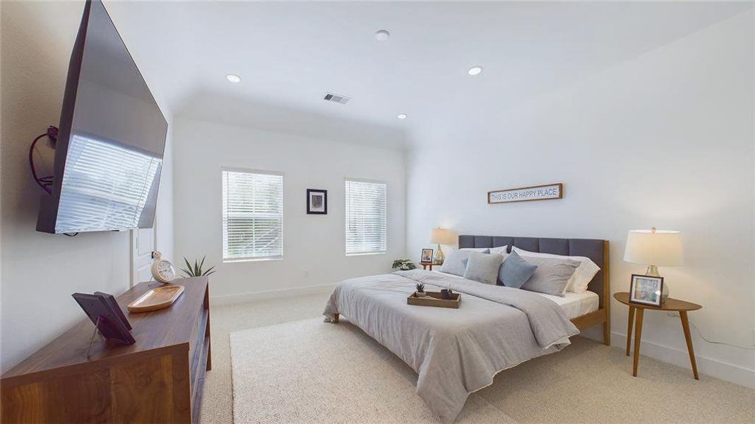 Elegant & spacious primary bedroom located on the 2nd floor. The high ceilings, with recessed lighting, are prewired and blocked for ceiling fans (not included).