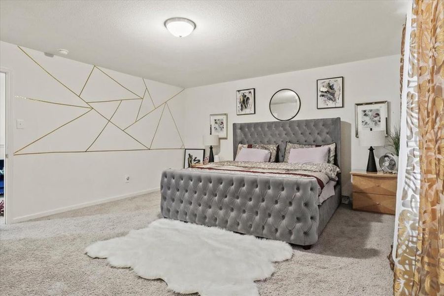 Carpeted bedroom featuring a textured ceiling