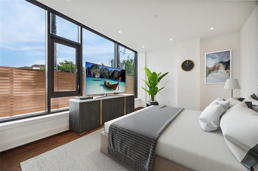 This contemporary primary bedroom suite features an abundance of large windows, including an operable one to let in fresh air,  providing loads of natural light and direct views to your own private fenced terrace. This unit offers an inviting indoor-outdoor living experience.