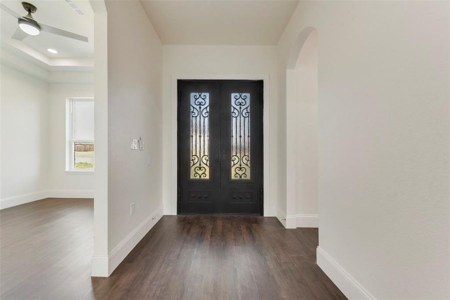 Foyer featuring ceiling fan and dark wood-type flooring