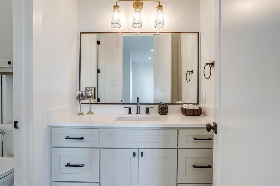 Bathroom featuring vanity and toilet