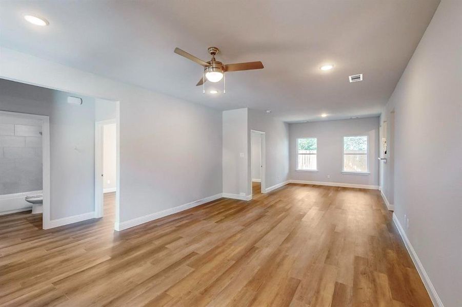 Unfurnished living room featuring light hardwood / wood-style floors and ceiling fan