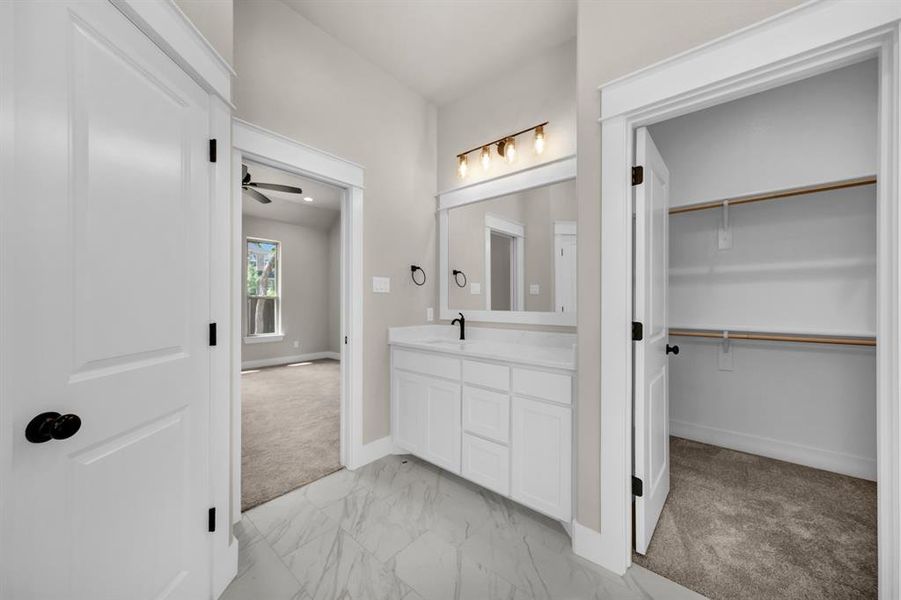 Bathroom featuring tile floors, ceiling fan, and vanity