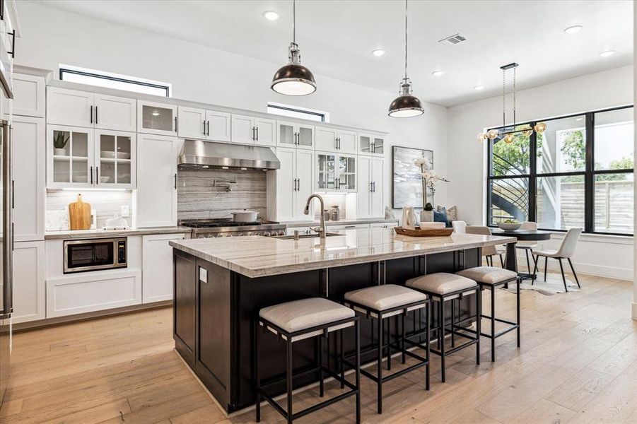 This modern kitchen features a suite of KitchenAid appliances, including a smart commercial-style gas range.