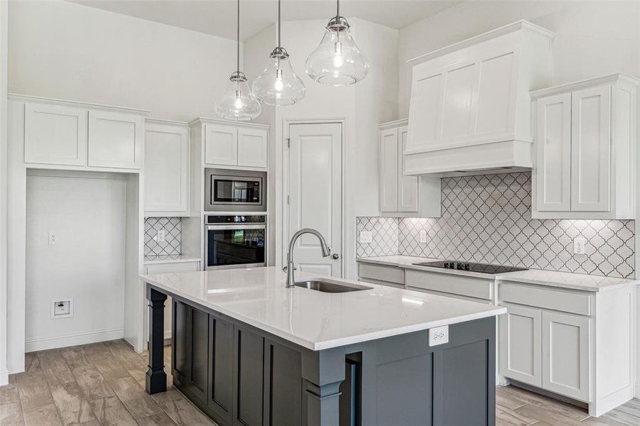 Double Ovens and Electric Cooktop with Large Island