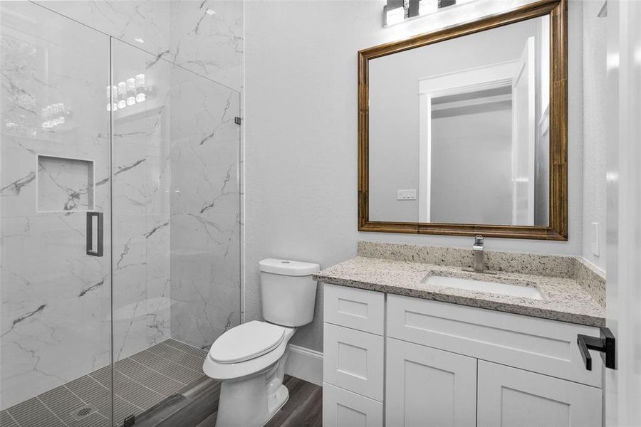 Bathroom #3. All SecondaryAll Secondary Bathrooms offer walk-in showers with frameless glass and large inset storage and the same clean modern finishings used throughout the home, along with Delta sinks, faucets and shower shower finishings.