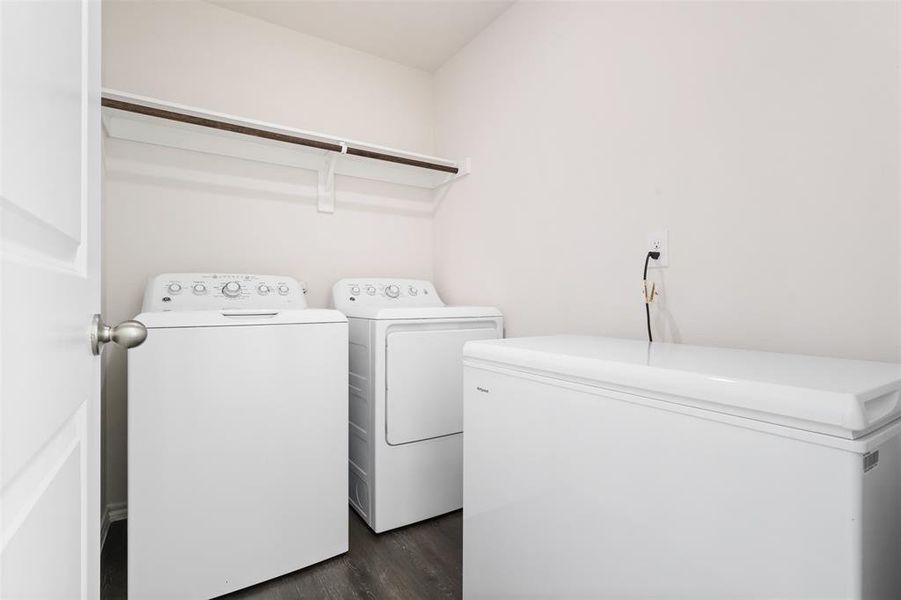 Laundry area with washer and dryer and dark hardwood / wood-style floors