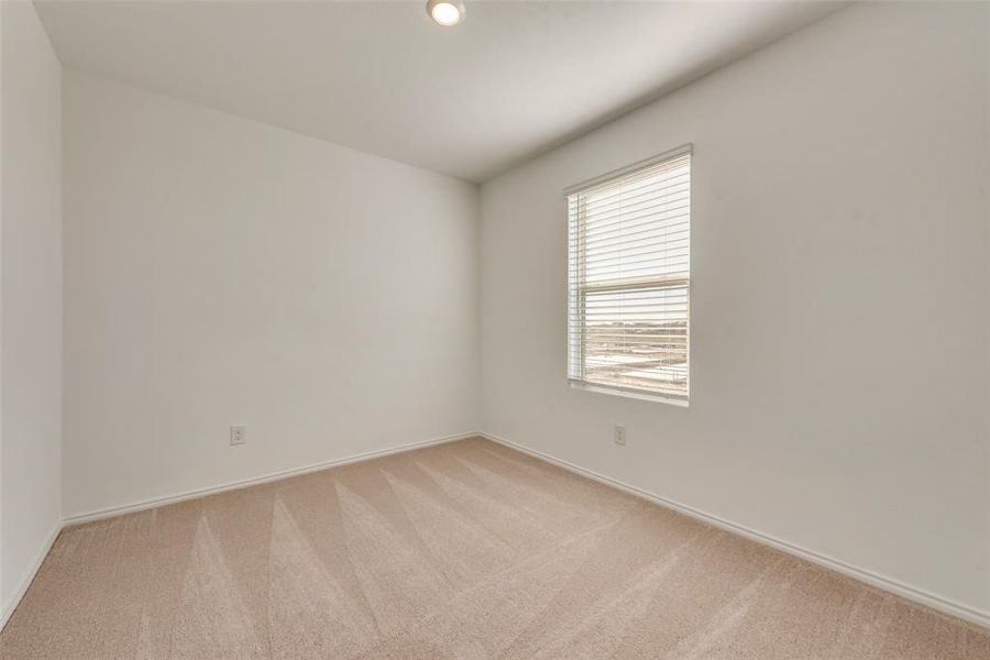 Empty room with light colored carpet