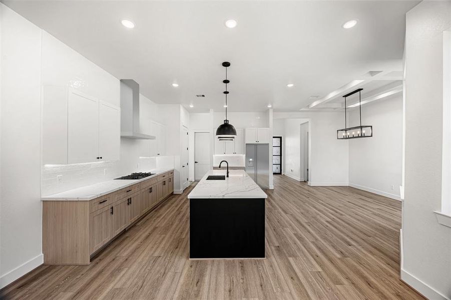 Gorgeous, open floor plan with vinyl plank flooring, and modern finishes. *Appliances and vent hood are photoshopped*